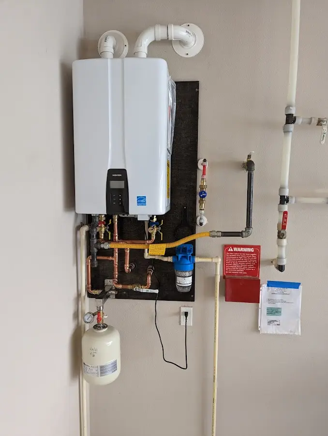 Professional plumber installing copper piping in a Birch Run home